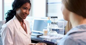 A doctor speaking with a patient about breast implant surgery