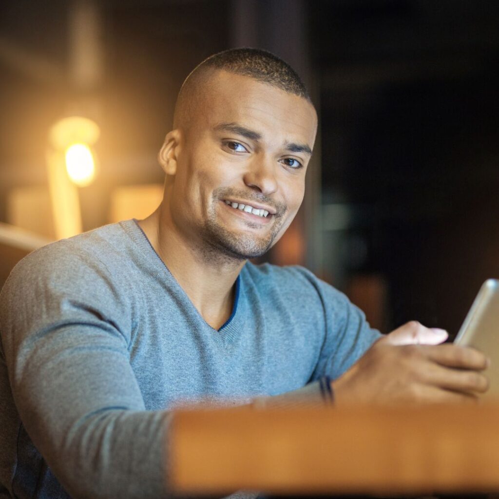 smiling man using phone