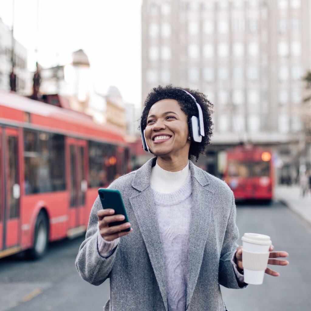 Happy woman listening to music on headphones