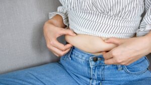 A woman with belly fat.