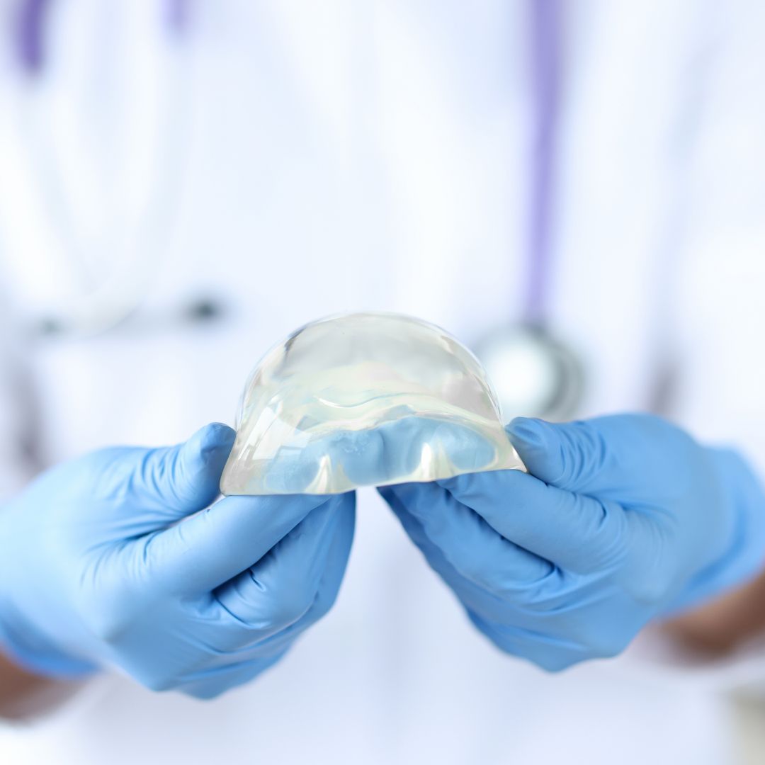 Doctor holding breast implant