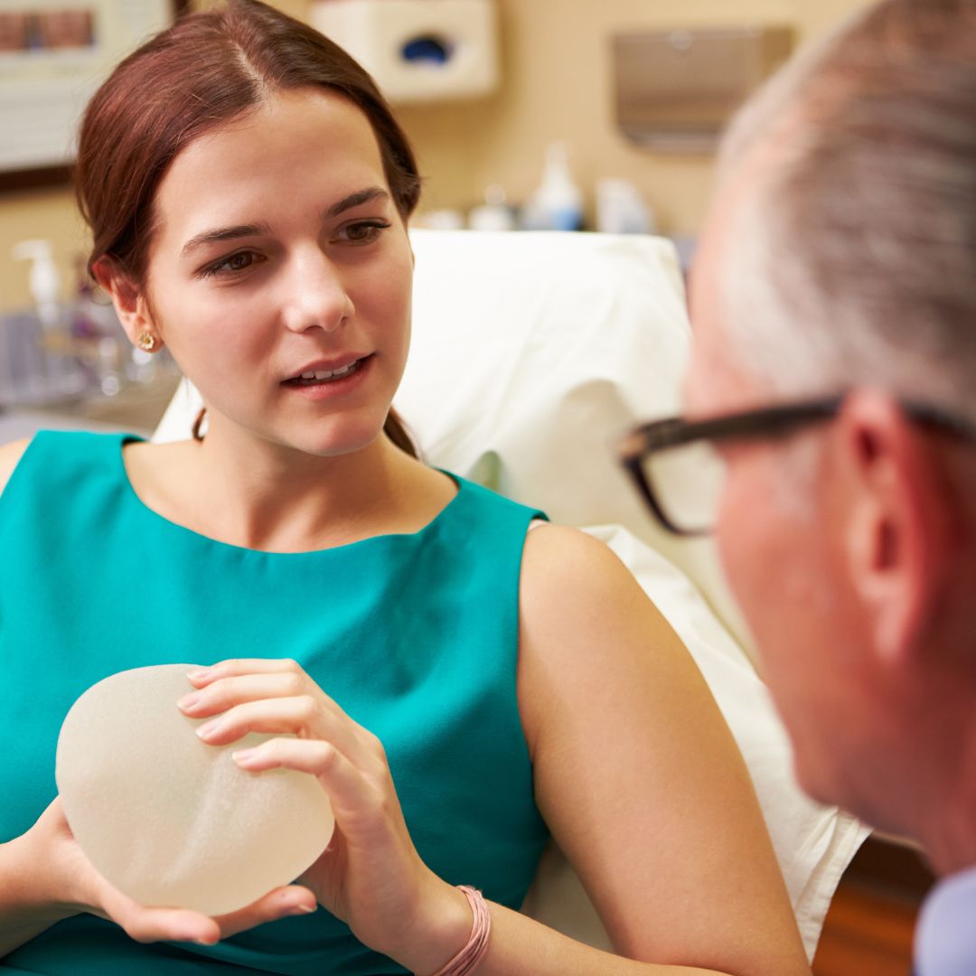 Patient discussing breast implants with plastic surgeon