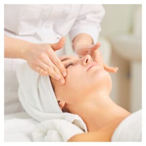 a woman receiving a facial massage