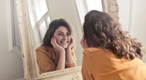a woman smiling in the mirror