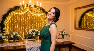 A woman smiling confidently in a festive, elegant setting